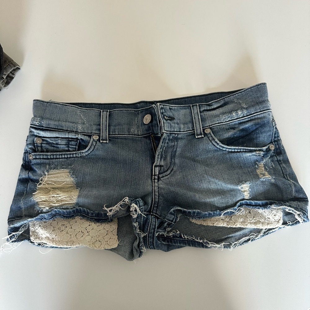 Jean shorts with eyelet detail sticking out